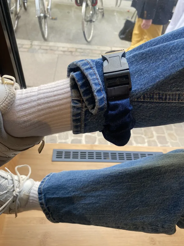An Indigo Denim strap around a rolled jeans hem