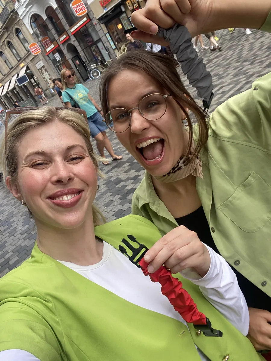 Two of the Pants Protector founders taking a selfie on a Copenhagen street, holding up straps